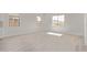 Spacious bedroom features three large windows and light wood flooring at 11949 W Parkway Ln, Avondale, AZ 85323