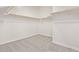 Walk-in closet featuring neutral carpeting and shelving at 11949 W Parkway Ln, Avondale, AZ 85323