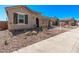 Exterior angle shot of the home with desert landscaping and a beautiful brick driveway at 11949 W Parkway Ln, Avondale, AZ 85323