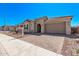 Charming single-story home featuring a covered porch and a brick driveway at 11949 W Parkway Ln, Avondale, AZ 85323