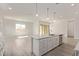 Open-concept kitchen with a large island and pendant lighting, flowing into the adjacent living space at 11949 W Parkway Ln, Avondale, AZ 85323