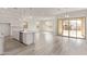 Bright open floor plan features a kitchen island with seating and sliding doors to the outdoor area at 11949 W Parkway Ln, Avondale, AZ 85323