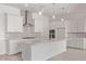 Bright kitchen featuring white cabinets, stainless steel appliances, a gray backsplash, and a large quartz island at 11949 W Parkway Ln, Avondale, AZ 85323