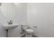 Neutral half bath with pedestal sink, toilet, and wood-look flooring at 12003 W Parkway Ln, Avondale, AZ 85323