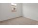 Bedroom featuring neutral carpet, a single window, and light walls at 12003 W Parkway Ln, Avondale, AZ 85323