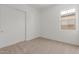 Cozy bedroom featuring neutral carpet, a window for natural light, and closet at 12003 W Parkway Ln, Avondale, AZ 85323