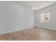 Open dining area with wood-look flooring and a modern chandelier at 12003 W Parkway Ln, Avondale, AZ 85323