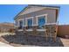 Beautiful exterior of a home with stone accents, a manicured gravel garden, and large, bright windows at 12003 W Parkway Ln, Avondale, AZ 85323