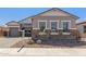 Exterior view of a home showcasing a well-maintained yard and stone accents, blending elegance and curb appeal at 12003 W Parkway Ln, Avondale, AZ 85323