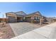 Attractive home featuring a paver driveway, multiple car garage, and elegant stone accents on the facade at 12003 W Parkway Ln, Avondale, AZ 85323