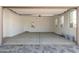 Finished two car garage with concrete floor, water heater, and utility sink at 12003 W Parkway Ln, Avondale, AZ 85323