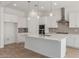 Bright kitchen features white cabinets, stainless appliances, quartz countertops, and pendant lighting at 12003 W Parkway Ln, Avondale, AZ 85323