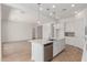 Bright kitchen with a large island and stainless appliances, seamlessly flowing into the living area at 12003 W Parkway Ln, Avondale, AZ 85323