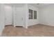 Inviting entry featuring wood-look floors, a stylish front door, and natural light at 12003 W Parkway Ln, Avondale, AZ 85323