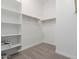 Walk-in closet featuring shelving units, neutral carpet, and a clothing rod at 12003 W Parkway Ln, Avondale, AZ 85323