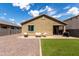 Spacious backyard featuring gravel landscaping, artificial grass, and a patio area with seating at 18147 W Ida Ln, Surprise, AZ 85387