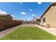 A spacious backyard features low-maintenance landscaping, artificial turf, and a paved patio area at 18147 W Ida Ln, Surprise, AZ 85387