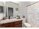 Bathroom features a decorative shower curtain and a vanity with towels and decor at 18147 W Ida Ln, Surprise, AZ 85387