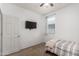 Simple bedroom featuring a ceiling fan, window and flat screen television at 18147 W Ida Ln, Surprise, AZ 85387