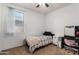 Bedroom features a ceiling fan, window with blinds, and desk area at 18147 W Ida Ln, Surprise, AZ 85387