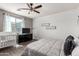 Bedroom featuring a crib, black dresser, grey walls and dark wood floors at 18147 W Ida Ln, Surprise, AZ 85387