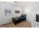 Cozy bedroom featuring a ceiling fan, a small window and decorative painting at 18147 W Ida Ln, Surprise, AZ 85387