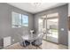 Breakfast nook with table and chairs adjacent to backyard sliding glass door and window at 18147 W Ida Ln, Surprise, AZ 85387