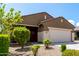 Attractive single-story home with desert landscaping, a two-car garage, and a decorative wreath at 18147 W Ida Ln, Surprise, AZ 85387
