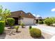 Single-story home with a two-car garage and a well-manicured front yard featuring mature landscaping at 18147 W Ida Ln, Surprise, AZ 85387