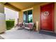 Inviting front porch area features outdoor seating, a decorative wreath, and a 'HELLO' sign at 18147 W Ida Ln, Surprise, AZ 85387