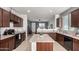 Well-equipped kitchen featuring dark wood cabinetry and an island with a light countertop at 18147 W Ida Ln, Surprise, AZ 85387