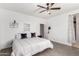 Bright main bedroom with a ceiling fan, closet, and decor at 18147 W Ida Ln, Surprise, AZ 85387