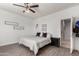 Bright main bedroom with a ceiling fan, wood floors, and decor at 18147 W Ida Ln, Surprise, AZ 85387