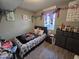Cozy bedroom with a double bed, dresser, and window at 206 N 5Th St, Avondale, AZ 85323