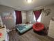 Charming bedroom with double bed, window, and red chair at 206 N 5Th St, Avondale, AZ 85323