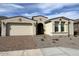 Inviting single-story home boasts a two-car garage, desert landscaping, and neutral color palette at 10262 W Columbus Ave, Avondale, AZ 85392