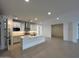 Modern kitchen with white cabinets, quartz countertops, and a large center island at 10262 W Columbus Ave, Avondale, AZ 85392