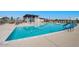 Community pool with sun loungers and shaded seating areas for residents to relax and enjoy the water at 10262 W Columbus Ave, Avondale, AZ 85392