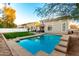 Inviting backyard oasis featuring a sparkling pool and grassy area at 1232 E Strawberry Dr, Gilbert, AZ 85298