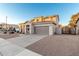 Two-story house with a large garage and desert landscaping at 1232 E Strawberry Dr, Gilbert, AZ 85298