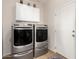 Laundry room with modern washer and dryer, plus cabinets at 1232 E Strawberry Dr, Gilbert, AZ 85298