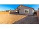 A spacious backyard featuring fresh sand and a covered patio, perfect for outdoor relaxation and entertaining at 5338 W Manzanita Dr, Glendale, AZ 85302