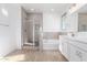 Primary bathroom featuring a shower, tub, and double vanity with tile accents at 5338 W Manzanita Dr, Glendale, AZ 85302