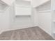 Walk-in closet featuring carpeting and built-in shelving and hanging rods for storage at 5338 W Manzanita Dr, Glendale, AZ 85302