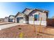 Attractive single-Gathering home with stone accents, gray trim, desert landscaping, and paved driveway to a two-car garage at 5338 W Manzanita Dr, Glendale, AZ 85302