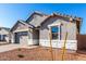 Attractive single-Gathering home with stone accents, gray trim, desert landscaping, and paved driveway to a two-car garage at 5338 W Manzanita Dr, Glendale, AZ 85302