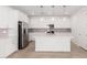A modern kitchen showcases white cabinets, stainless steel appliances, and a central island, all beneath pendant lights at 5338 W Manzanita Dr, Glendale, AZ 85302