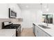 Well-lit kitchen with stainless appliances, island with sink, and seamless flow to a bright, airy outdoor patio at 5338 W Manzanita Dr, Glendale, AZ 85302