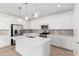 Modern kitchen featuring white cabinetry, stainless steel appliances, and a spacious island with pendant lighting at 5338 W Manzanita Dr, Glendale, AZ 85302