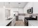 Bright kitchen with stainless steel appliances, a large island, and ample counter space with light backsplash at 5338 W Manzanita Dr, Glendale, AZ 85302